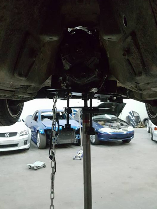 Toyota Soarer with trans jack holding gearbox